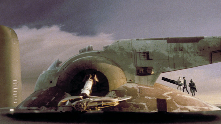 Fett instructs an Imperial officer where to store his frozen prisoner Han Solo